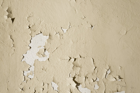 Natural background. Wall with a shabby and peeling paint and plaster. Contrast and volume, beigeの写真素材