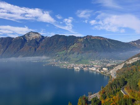 Aerial view of the mountain landscape and lake. Below a small town in central Switzerlandの写真素材