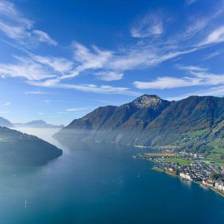 Aerial view of the mountain landscape and lake. Below a small town in central Switzerlandの写真素材