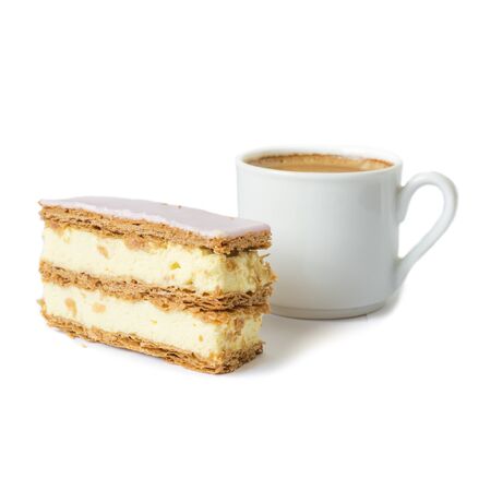 Puff cake with cream. Cup with black coffee in the background. Selective focus. Isolated objects on a white background.の写真素材