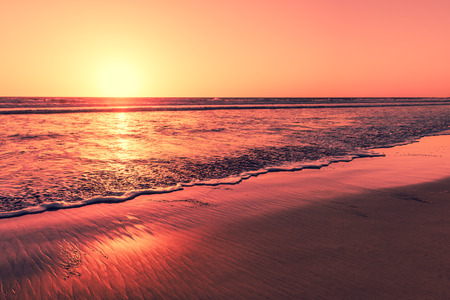 Sunset over the magnificent beach of California. Coast of Pacific ocean for an evening  meditative relaxation walks.の写真素材