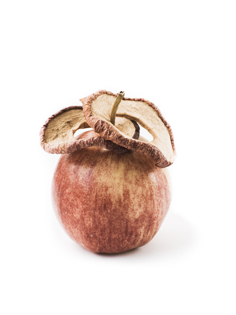 Fresh apple and dried apples slices.  Storing vitamins for the winter and spring period. Healthy food. Isolated objects on a white background. Book cover.の写真素材