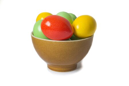 Painted colorful eggs in bowl. Feast of Easter. Isolated objects on a white background.の写真素材