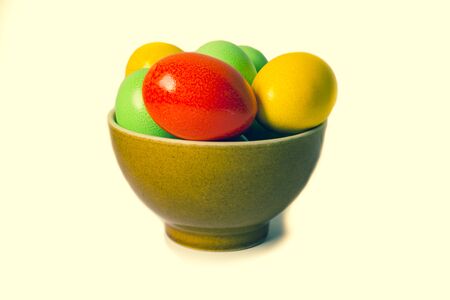 Painted colorful eggs in bowl. Feast of Easter. Isolated objects.の写真素材