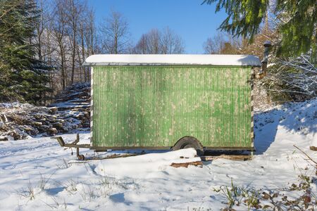 Trailer on wheels in the forest. Winter day. Snow drifts on spruce.の写真素材