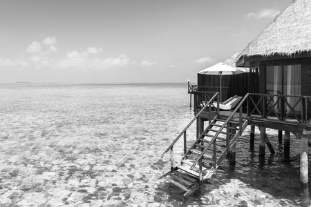 Panorama of tropical island resort with overwater bungalows in black and white. Maldives. Ari Atoll.の写真素材