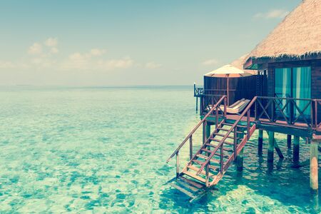 Panorama of tropical island resort with overwater bungalows at night. Maldives. Ari Atoll.の写真素材
