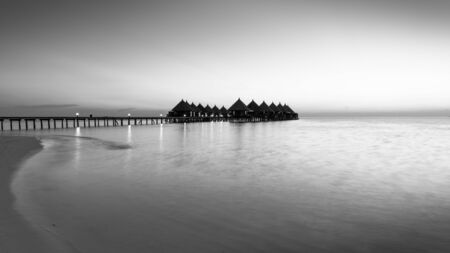Panorama of tropical island resort with overwater bungalows at night in black and white.  Maldives. Ari Atoll.の写真素材