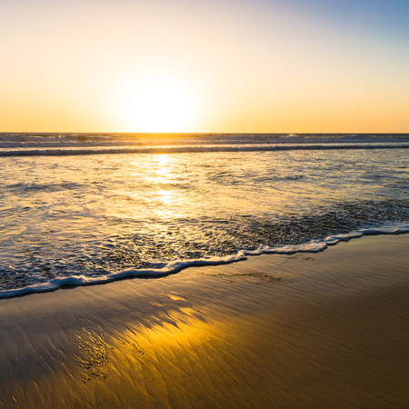 Sunset over the magnificent beach of California. Coast of Pacific ocean for an evening  meditative relaxation walks.の写真素材