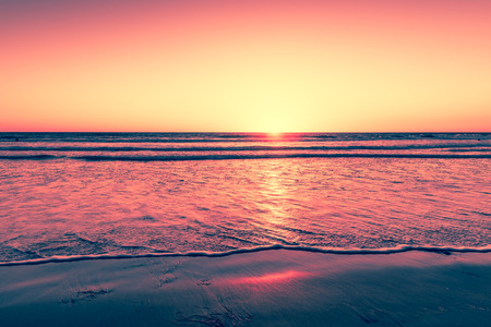 Sunset over the magnificent beach of California. Coast of Pacific ocean for an evening  meditative relaxation walks.の写真素材