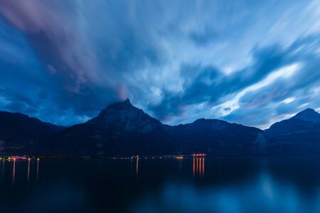 Sunset cloudy sky over mountains. Long exposure.の写真素材