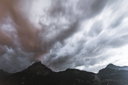 Sunset cloudy sky over mountains. Long exposure.の写真素材