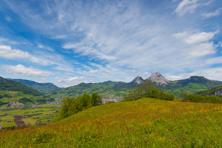 Impressive clouds over the mountains. Dramatic Sky. The little town  Schwyz. On the horizon a mountain peak Great  Mythen , Mythenregion.の写真素材