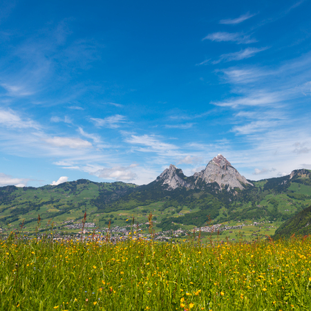 Impressive clouds over the mountains. Dramatic Sky. The little town  Schwyz. On the horizon a mountain peak Great  Mythen , Mythenregion.の写真素材