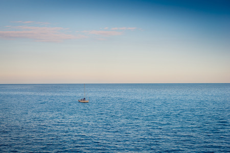 Evening on the Mediterranean Sea. In the distance small boatの写真素材