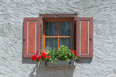 Window with flower pot on ledge in a village, eastern of Switzerlandの写真素材