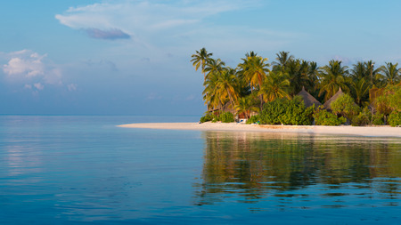 Panorama of a tropical island with a white sand beach and turquoise water of the ocean. Landscape l with palm trees.の写真素材