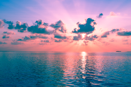 Magnificent panorama of sunset over the ocean. Rays of the sun shine through the clouds.の写真素材