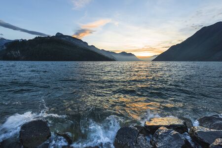 Alpine landscape in the lake. Windy day, waves splashes.の写真素材