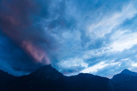Scary storm cloud over the mountains.の写真素材