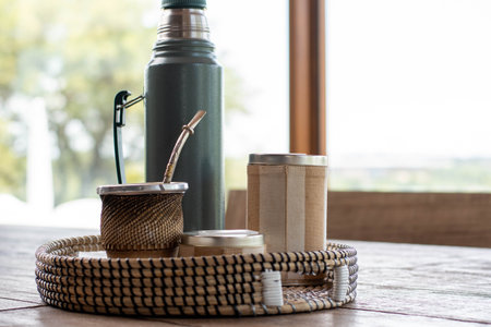 Coffee cup and flask on wooden table in coffee shopの写真素材