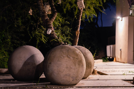 A vertical low angle shot of a pile of concrete balls on the street at nightの写真素材