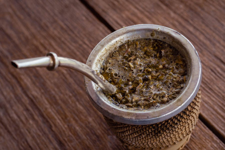 Coffee in a metal cup on a wooden background, top viewの写真素材