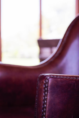 Close up of vintage leather armchair in the living room. Select focus.の写真素材