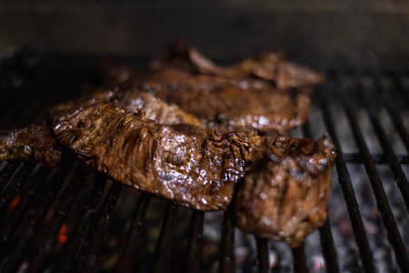 Beef steak on the barbecue grill with flames and smoke. Select focus.の写真素材