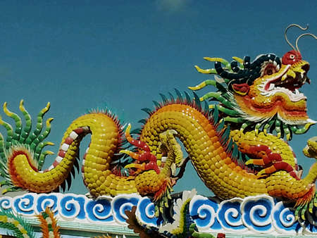 Dragon statue under blue sky background in chinese temple.の素材