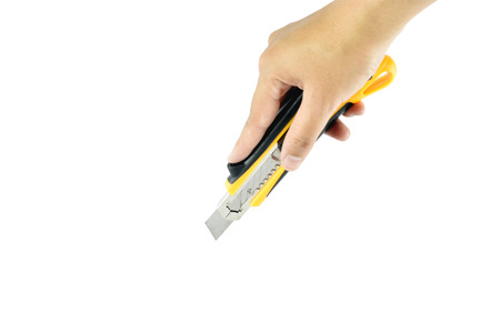 hand and yellow Cutter on white background with clipping paths.