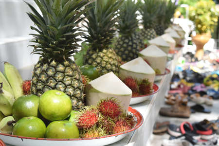 banana, rambutan, coconut, orange and pineapple in thai zinc salverの写真素材