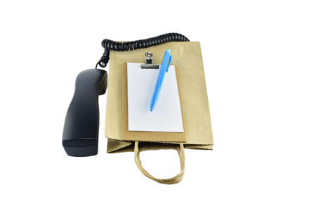 Brown paper shopping bag with telephone on white background with clipping pathsの写真素材