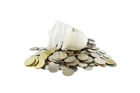 Coins heap with light bulb (energy savings concept) on white background with clipping paths.