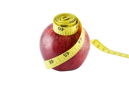 Red apple and yellow measuring tape concept for healthy diet and body weight control.の写真素材