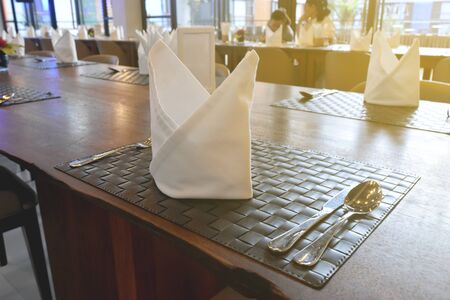 Wooden furniture design and empty tables set ready for breakfast, lunch or dinner.の写真素材