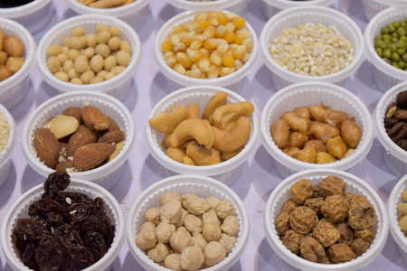 Cereal grains, seeds, beans on white plastic plate for background.の写真素材