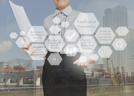 Businesswoman with presentation element of Verification Procedures concept for use in manufacturing, training and company system.の写真素材