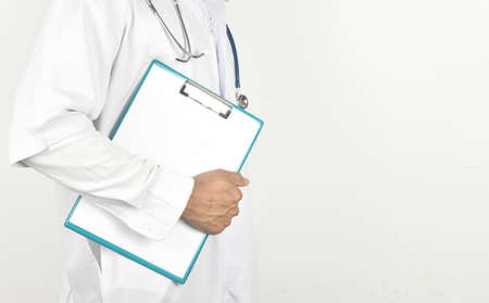 doctor with stethoscope working holding a clipboard on white background with copy space.