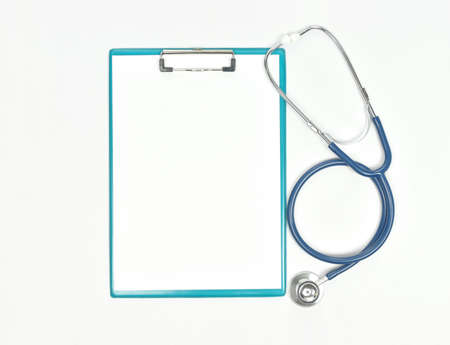 Top view of stethoscope and blank paper on clipboard on white background. Top view with copy space.