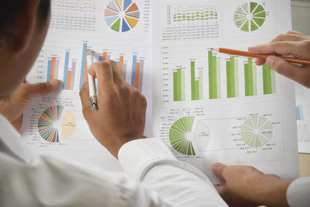 Business people group meeting. Teamwork with business people analysis financial graphs and charts on...