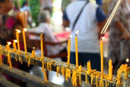 people lighing incense to pray from they faith in buddhismの写真素材