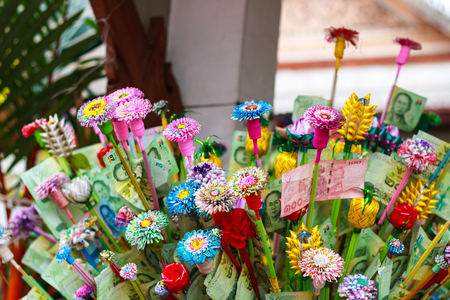 Pathum Thani, Thailand, -May,10,2017 : Thai buddhist people merit they money with insert money to stick they call "money tree" during Visakha Puja day. Editorial use onlyのeditorial素材