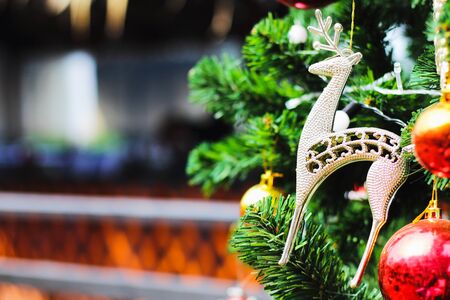 Golden deer decorated on a Christmas tree. There is space to put text. Christmas time that children have been waiting for A great celebration every New Year's Eveの写真素材