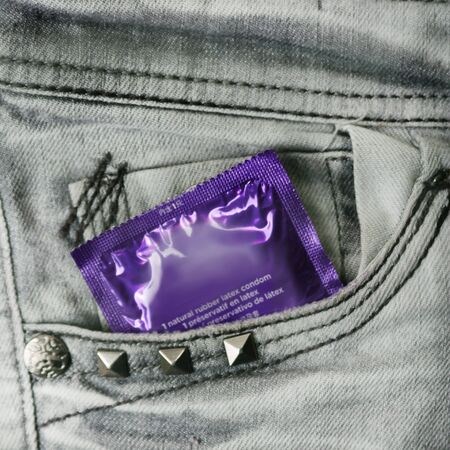 Condom in the grey jeans pocketの写真素材
