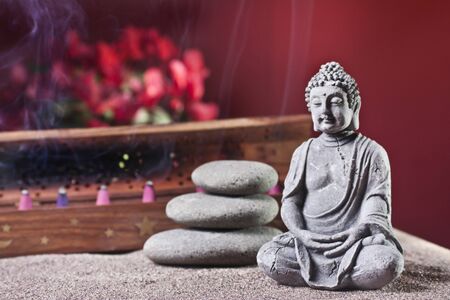 buddha and tower of stones, flowers and frankicenseの写真素材