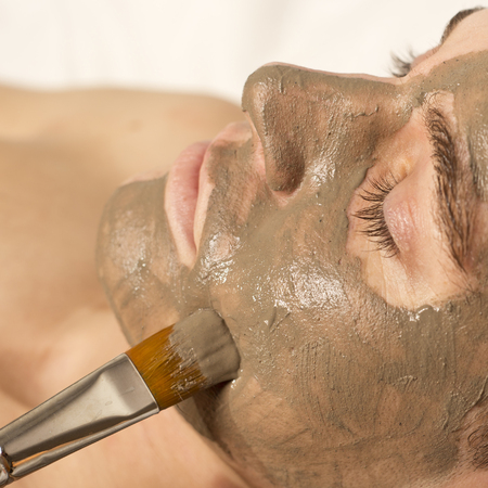 man receiving spa facial treatment, square formatの写真素材