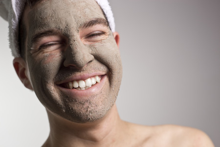 man with a mud mask on this face,smileの写真素材