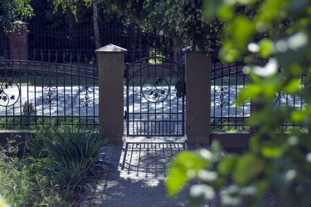 Modern garden gate. Autumnal garden view. Shadowsの写真素材