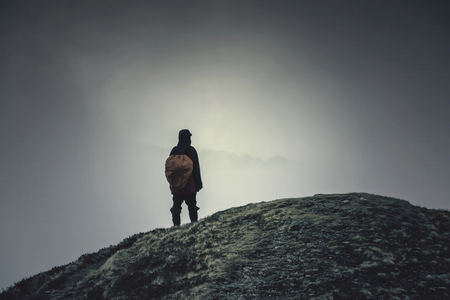 The wanderer on the mountain summit. Hipster, dark colorsの写真素材